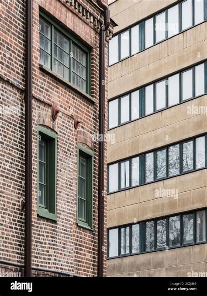 A tall brick building with a clock on it's side photo Free Kazakhstan Image on Unsplash