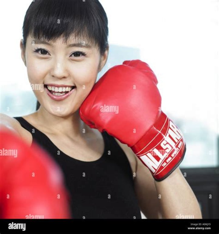a woman wearing boxing gloves with a quote on it
