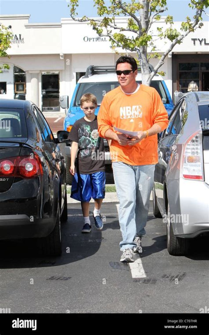 Dean Cain in an orange NBA League sweatshirt, out with his son