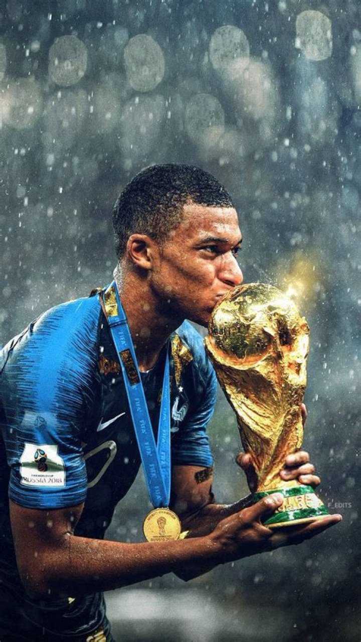 Download Kylian Mbappe Kissing World Cup Trophy Wallpaper