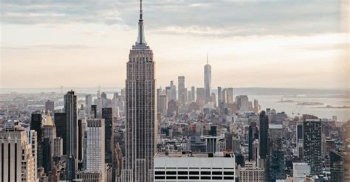 Empire State Building near multistage houses against ocean &middot; Free Stock