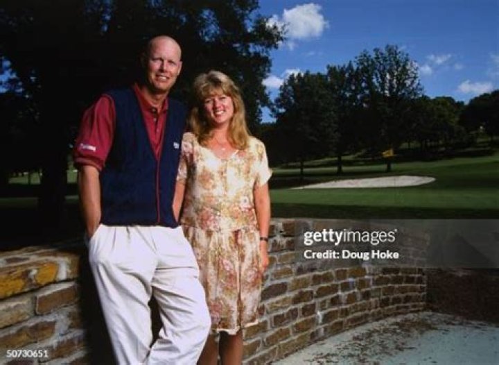 Feature. Portrait of Paul Azinger w. wife, Toni.; Azinger bald after