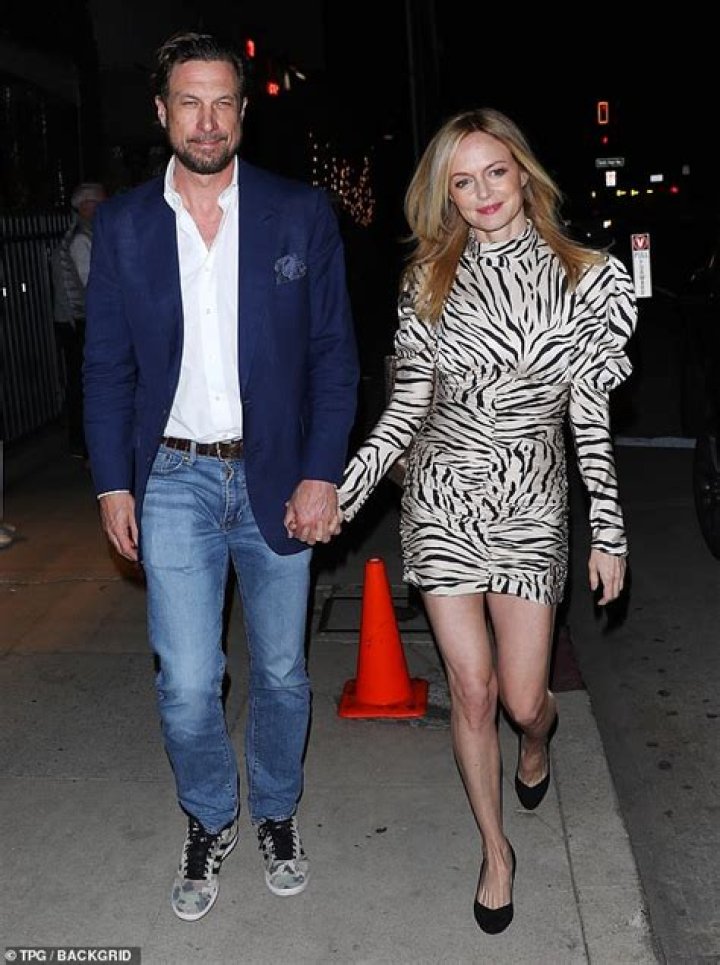 Heather Graham, 53, puts on a leggy display in a tiger print mini dress