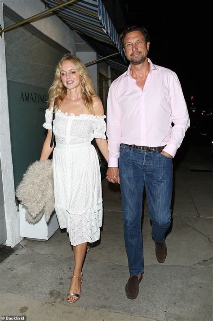 Heather Graham holds hands with snowboarder John de Neufville following