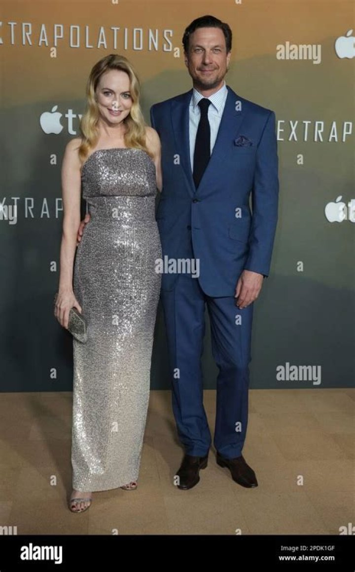 Heather Graham, left, and John de Neufville arrive at the Los Angeles