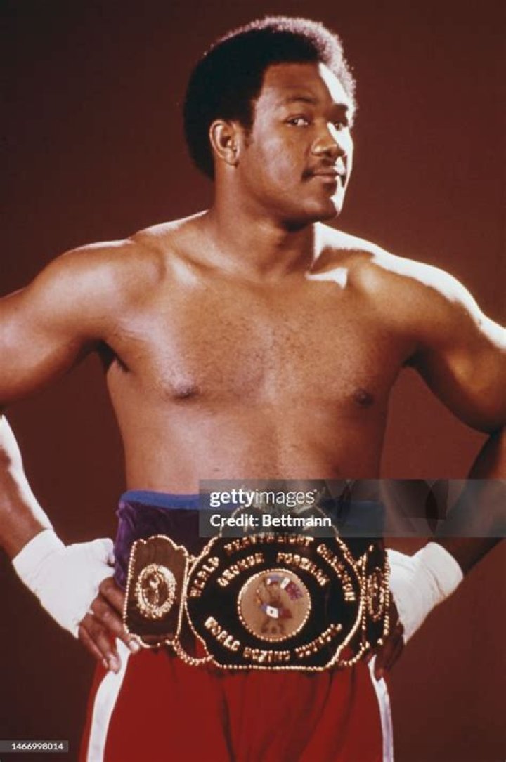 Heavyweight champion Foreman holds his 17monthold daughter
