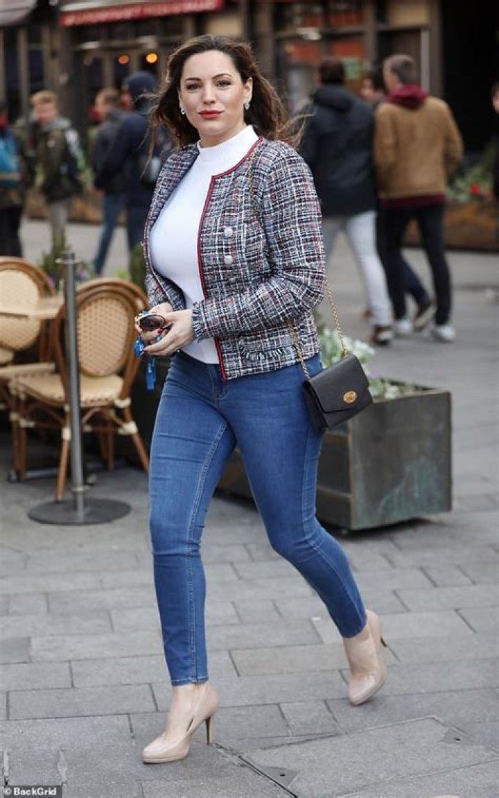 Kelly Brook flaunts her curves in a pretty playsuit as she enjoys the