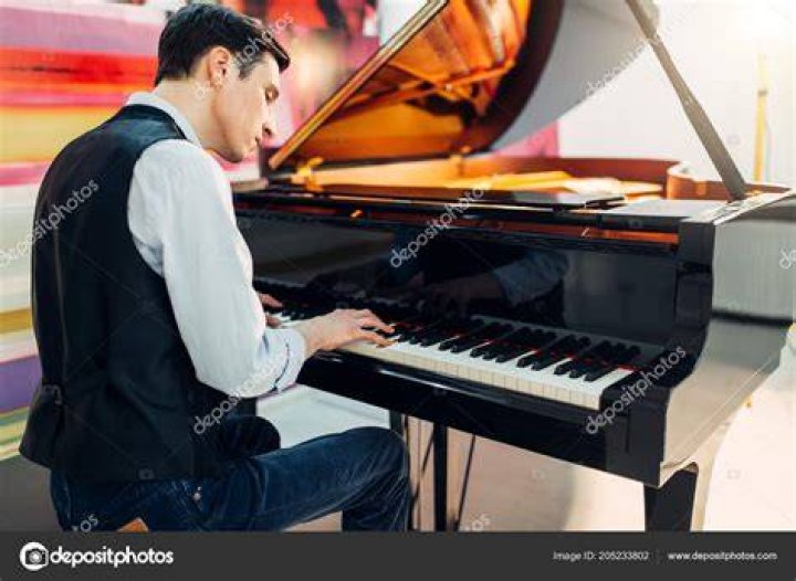 Male pianist at the classical black grand piano stock photo 1444114 Crushpixel