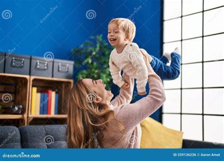 mother and son holding shopping paper bag with groceries customers