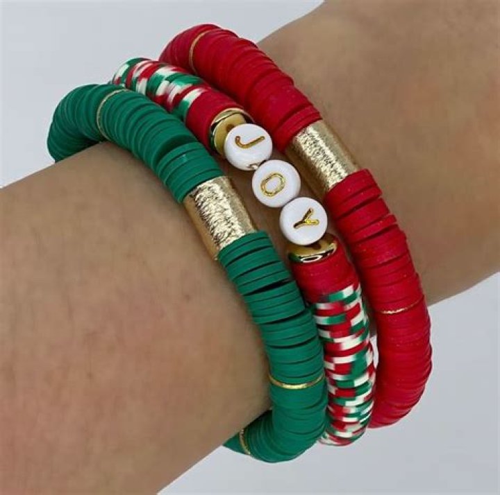Red Bracelet with Gold Accents Worn by Alison Oliver as Catton